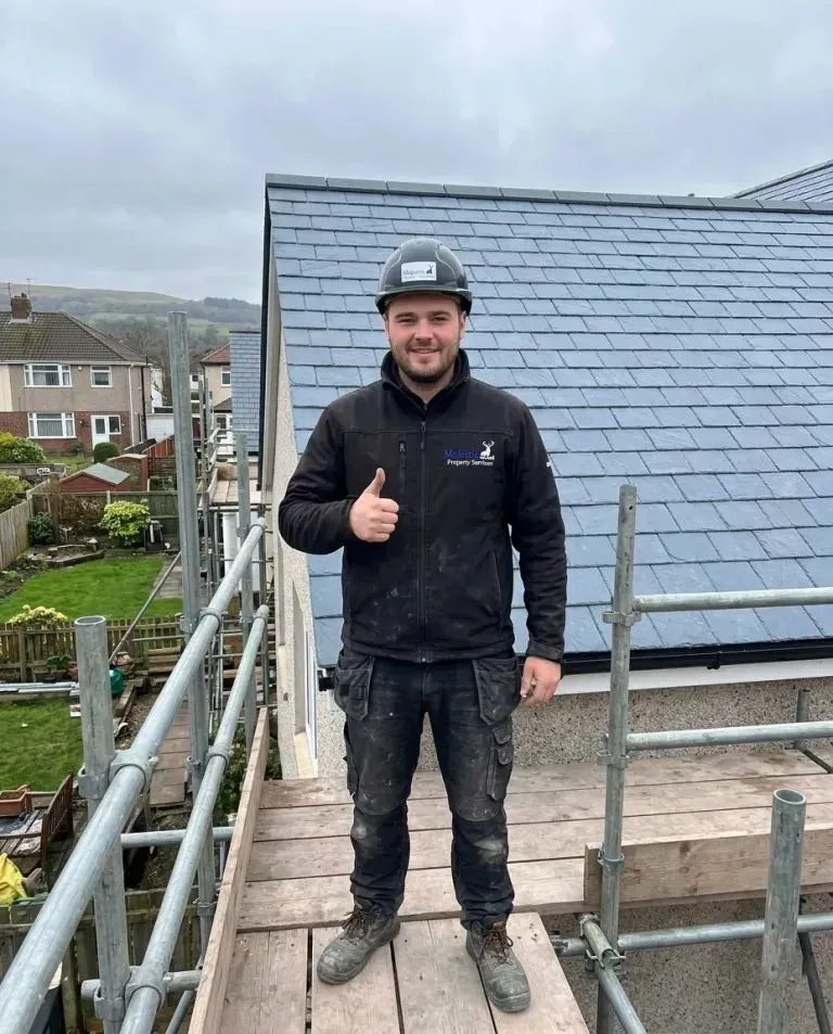 Majestic Services roofer on a completed slate roof in Bath